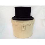 Lock & Co - A vintage Lock & Co, St James's Street, London top hat contained in oval, metal hat box,