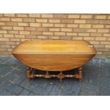 Ercol - a mid-elm Ercol drop leaf coffee table,