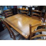 Ercol - a mid-elm Ercol dining table with two extending leaves approximately 75 cm x 114 cm x 79 cm