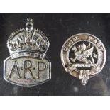 A silver hallmarked ARP badge and a Clan Leslie lapel badge marked 'silver'.