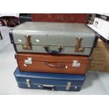 Three vintage suitcases.