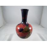 Moorcroft - A small Moorcroft pottery bud vase, decorated with pomegranate, signed to the base,