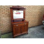 A two door, one drawer sideboard with mirror and drawer, two cupboards below,