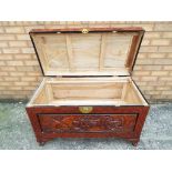 A large highly carved camphor chest raised on four supports,