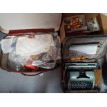 A vintage suitcase containing a quantity of crafting and sewing equipment and an Oliver MT13