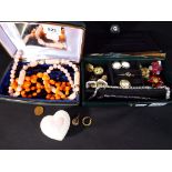 Two jewellery boxes containing a quantity of paired earrings, enamelled brooches, necklaces,