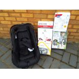 A child's car seat with a Phil & Teds Lazy Ted in original box,