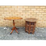 An oval occasional table on casters and a hexagonal highly carved table (2)