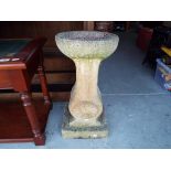 A concrete bird bath,