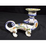 A vintage tin glaze dragon candlestick.