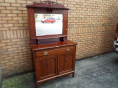 A two door, one drawer sideboard with mi