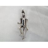 A silver tin man pendant. Estimate £30 -