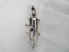 A silver tin man pendant. Estimate £30 -