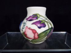 Moorcroft - a Moorcroft sweet pea vase,