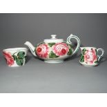 Wemyss Ware - A Wemyss teapot, sucrier and creamer, decorated in the Cabbage Rose pattern,