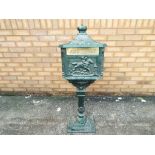 A cast iron letter box with stand, approximate height 120 cm, [in two pieces for transportation].