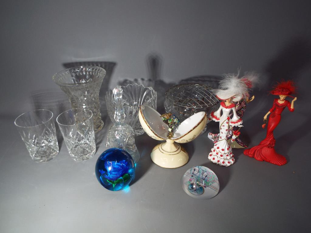 A mixed lot of glassware to include vases, drinking glasses, paperweights and similar,