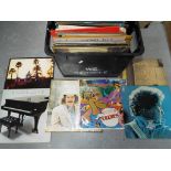 A quantity of 33 rpm vinyl records to include Bob Dylan, The Beatles, George Harrison, John Lennon,