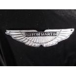 A white metal wall plaque scribed 'Aston Martin', 29.