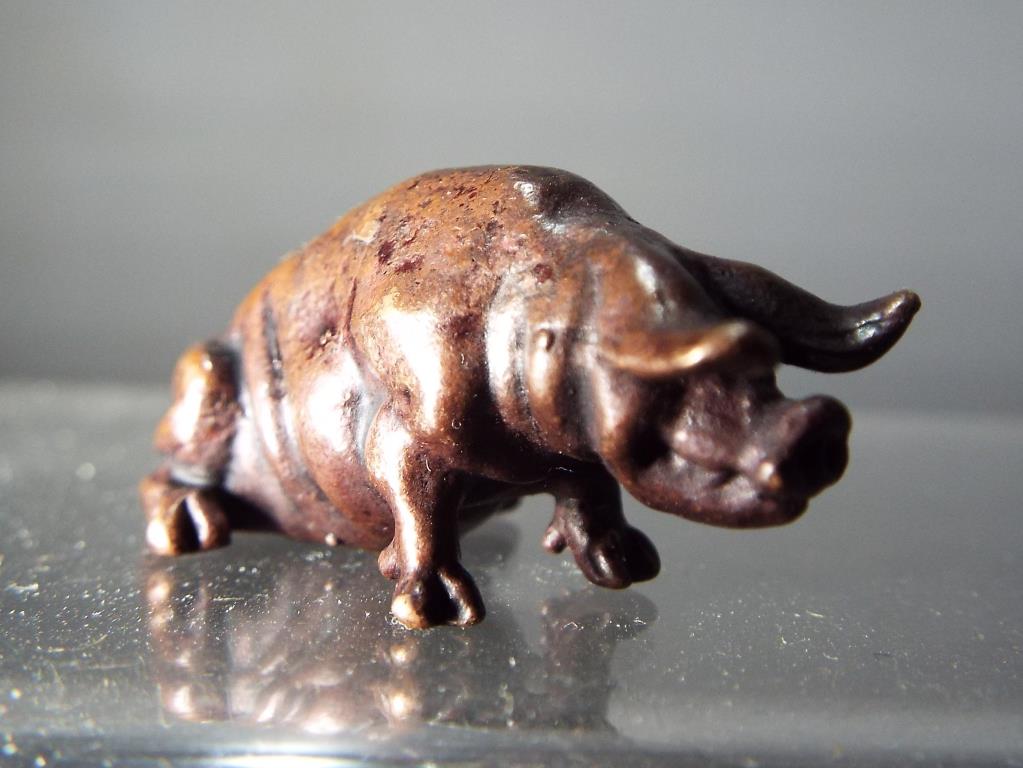 A diminutive hot cast bronze study of a seated pig. - Image 2 of 2