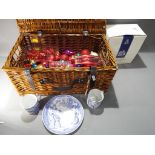 A good quality wicker picnic basket containing a large quantity of Christmas baubles and