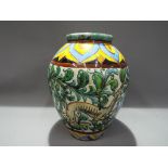 A European hand painted urn shaped ceramic vase, with a high glazed finish,