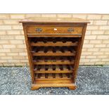 A good quality wine cabinet with a single draw, approximately 89 cm x 60 cm x 36 cm.
