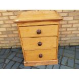 Antique pine chest of three drawers with handles measuring approximately 82 cm x 65 cm x 53 cm.