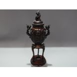 Bronze - a hot cast bronze incense burner with twin handled urn body,