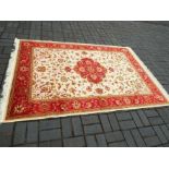 A Keshan carpet with a beige ground,