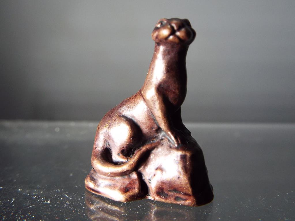 A diminutive hot cast bronze in the form of an otter seated on rocks. - Image 2 of 2