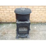 A cast iron gas/log burner, approximate height 76 cm.