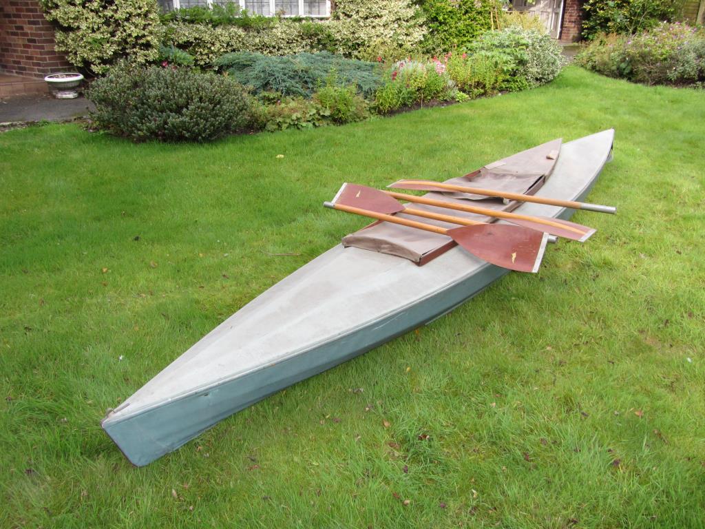A vintage Kayak and three pairs of paddles, the kayak approx 4.