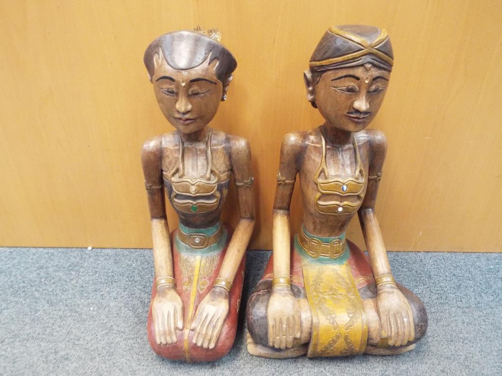 Two carved wood models depicting Rama and Sita,