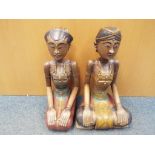 Two carved wood models depicting Rama and Sita,