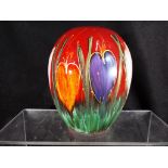 Anita Harris - a globular vase hand painted with crocuses on a red ground, signed to the base,