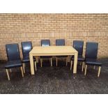 A modern dining table approximately 75 cm x 150 cm x 90 cm and six chairs.