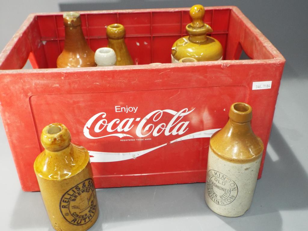 Breweriana - a Coca Cola branded crate, containing a quantity of ceramic jugs, tanker by TJ Green.