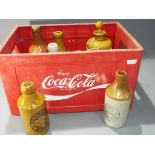 Breweriana - a Coca Cola branded crate, containing a quantity of ceramic jugs, tanker by TJ Green.