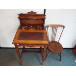A Victorian writing desk with leather top, two glass inkwells with lids detached and original key,