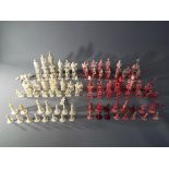 Three sets of 19th Century Canton worked ivory chess pieces,