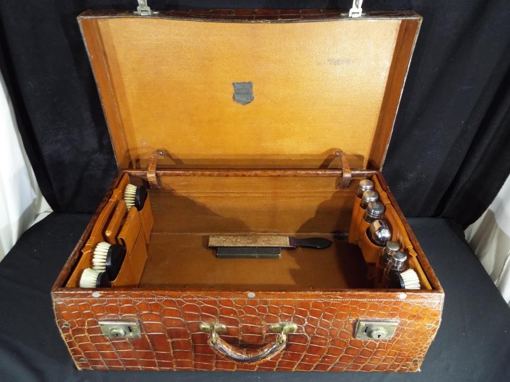 An early 20th century crocodile suitcase by the North West Tanner and Co Limited Cawnpore [Kampur] - Image 2 of 11