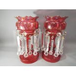 Two Cranberry glass hand-painted lustre's with relief decoration and gilded highlights,