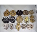 A collection of military cap badges to include Liverpool Scottish,