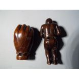 Netsuke - two vintage dark wood Japanese netsukes one in a form of a hand, holding a small monkey,