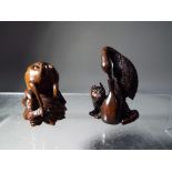 Netsuke - two vintage dark wood Japanese netsukes one in a form of a large bird,