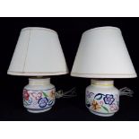 A pair of Poole Pottery table lamps, floral decoration with shades,