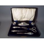 A silver hallmarked cased grooming set,