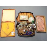 A vintage jewellery box containing a quantity of vintage costume jewellery to include some 925 and