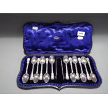 A Victorian set of twelve hallmarked sterling silver teaspoons and sugar tongs,